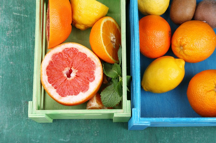 Citrus fruits in crates: oranges, lemons, grapefruit
