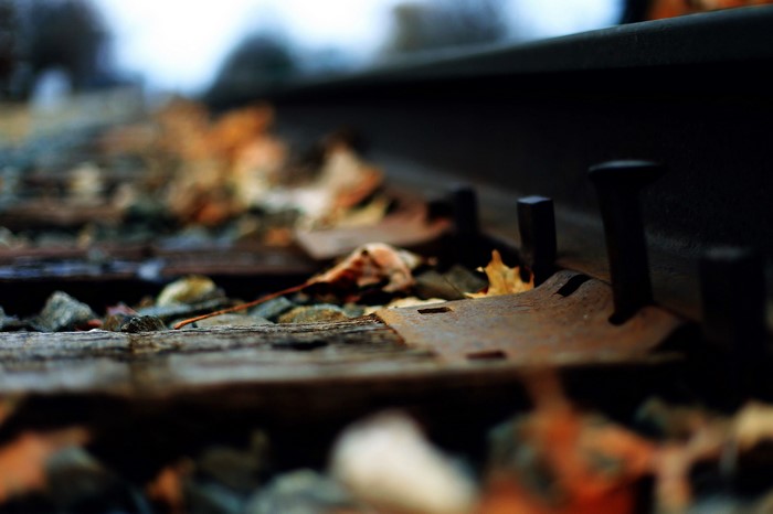 Railroad tracks with autumn leaves and gravel