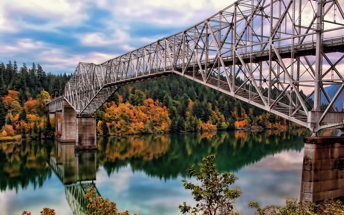 Steel Truss Bridge over a River with Autumn Trees