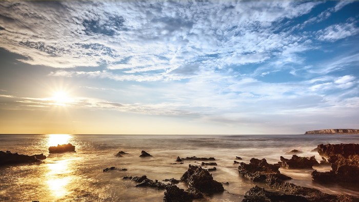 Sea Coast with Sun and Clouds