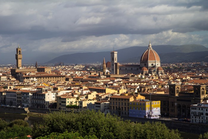 Florence cityscape with Duomo and Palazzo Vecchio under clouds