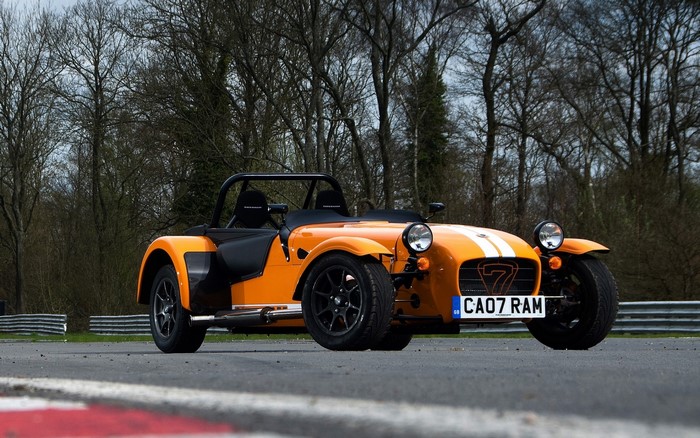 Orange Caterham 7 Supersport car on a race track