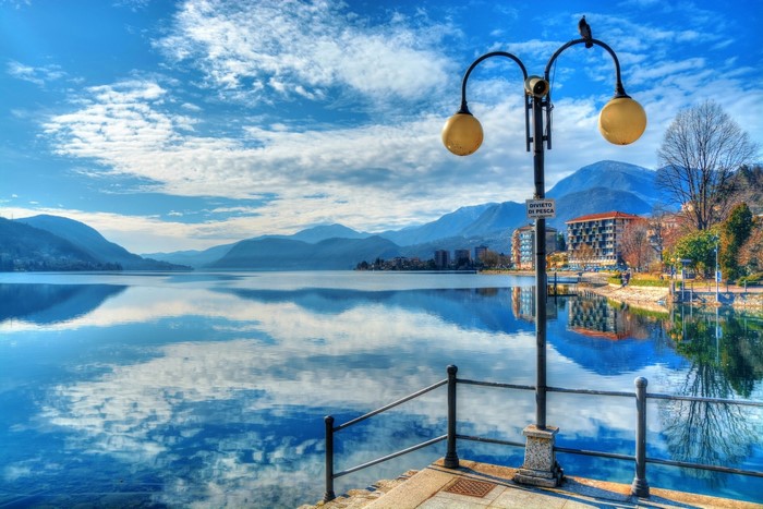 Lake Orta waterfront with mountains and street lights