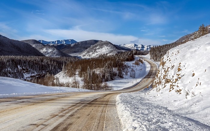 Winding mountain road through a snowy landscape