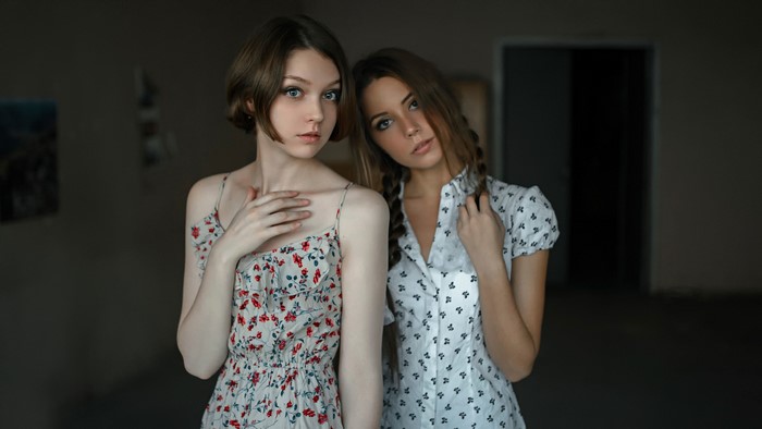 Two Young Women Posing Indoors
