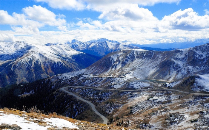 Snow-covered mountains with a winding road