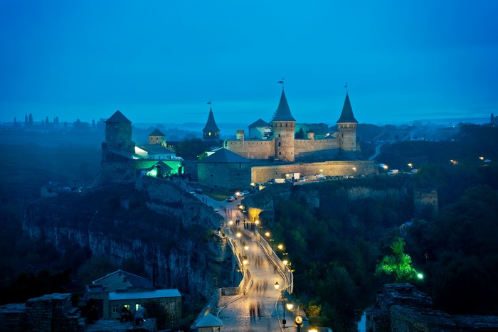 Kamianets-Podilskyi Castle in Ukraine at dusk