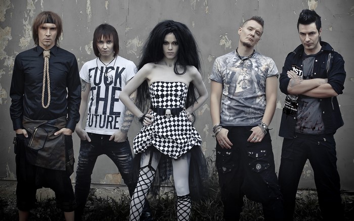 Band posing against a wall