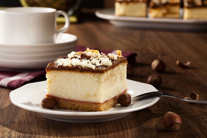 Slice of cheesecake with chocolate and nuts