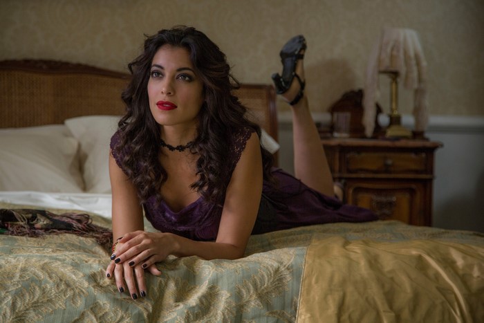 Stephanie Sigman from Spectre on a bed