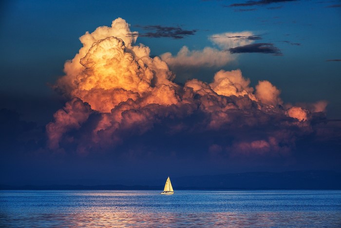 Sailboat on the sea with dramatic thunderclouds