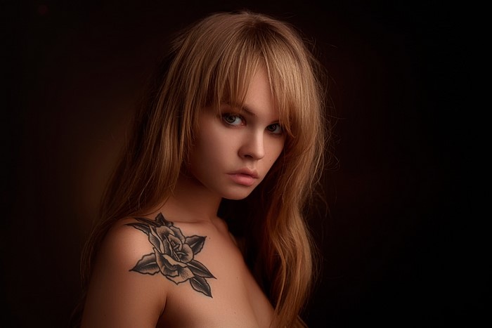 Woman with rose tattoo on shoulder