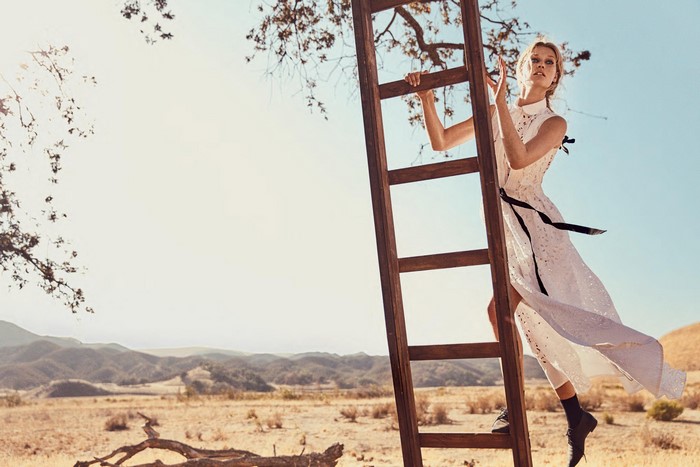 Toni Garrn on a ladder in a dress