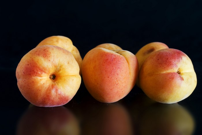 Apricots on a black background