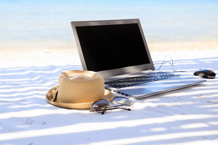 Laptop, Hat, and Sunglasses on a Beach