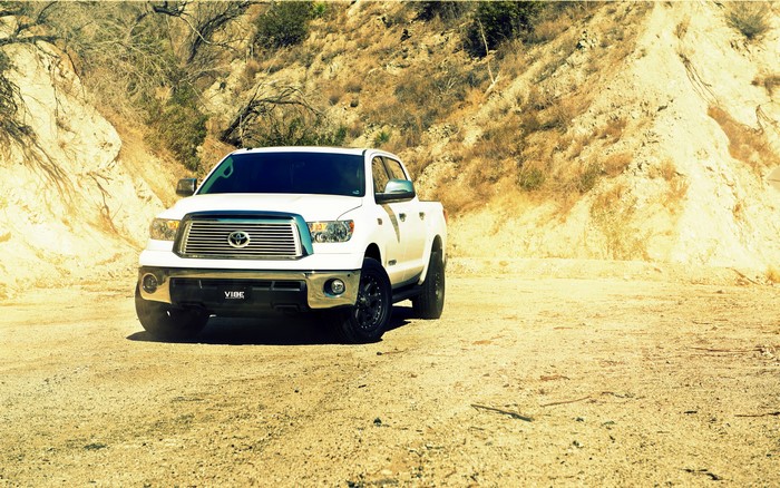 White Toyota Tundra on a dirt road