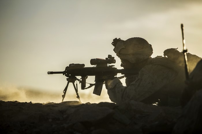 Soldier aiming a rifle on a tripod