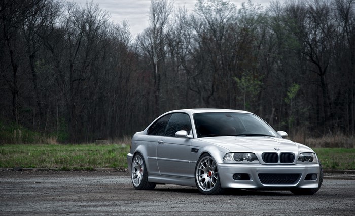 Silver BMW E46 M3 parked on gravel