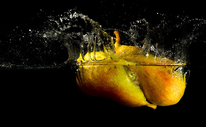 Pears splashing into water