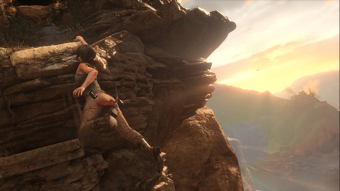Lara Croft climbing a rocky cliff in Rise of the Tomb Raider