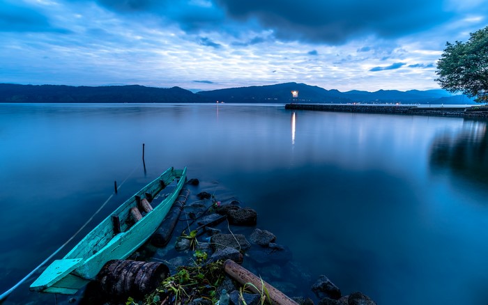Lake Toba caldera with a boat at dusk