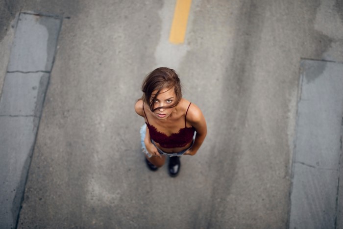 Woman looking up from a road