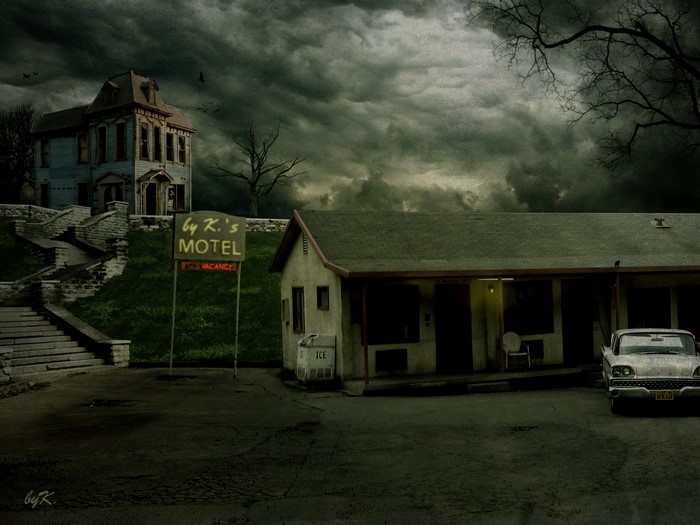 Motel and haunted house under stormy sky
