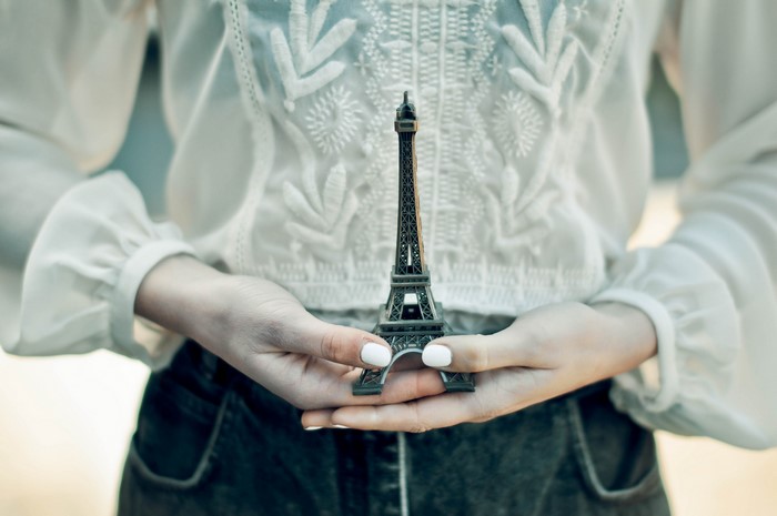 Hands holding Eiffel Tower souvenir