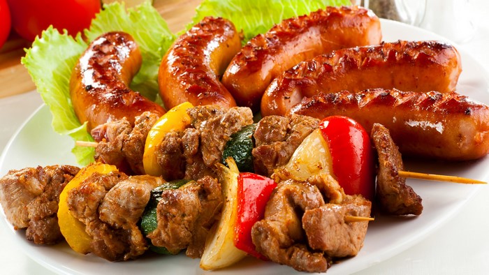 Grilled Sausages and Meat Skewers on a Plate