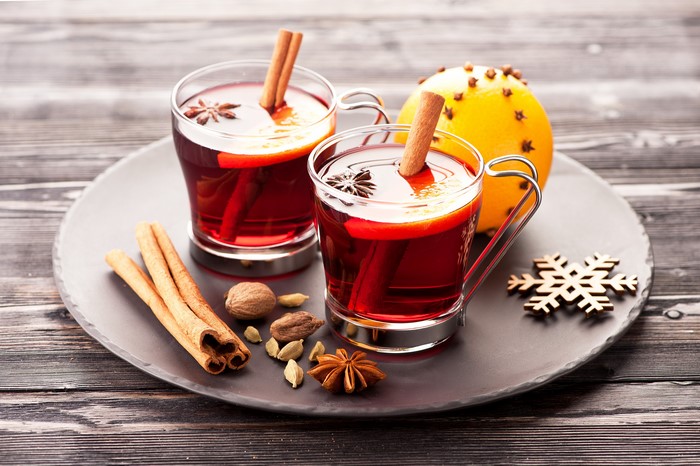 Two cups of mulled wine with spices and orange