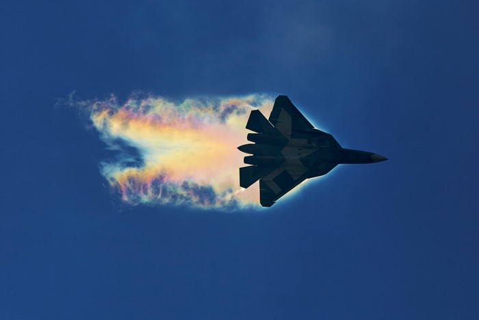 Sukhoi PAK FA fighter jet with rainbow contrail