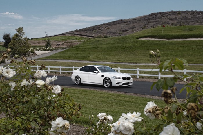 White BMW M5 F10 on a road