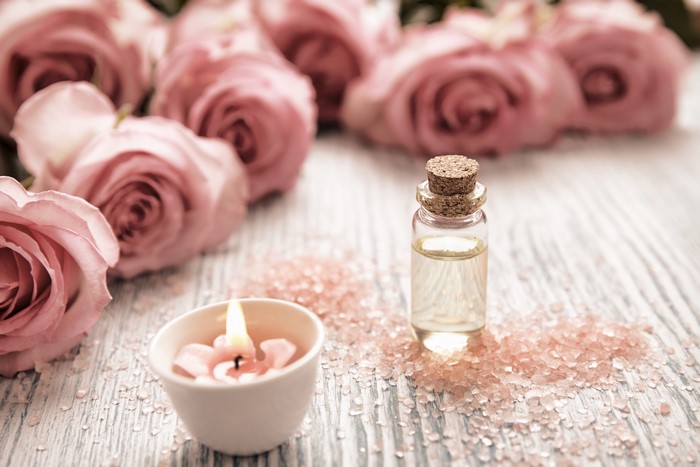 Pink Roses, Candle, and Essential Oil Bottle