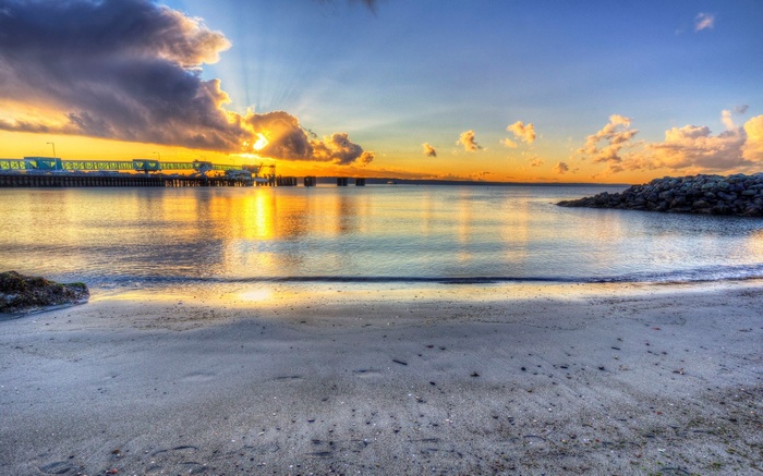 Sunset over a pier and beach