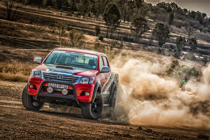 Red Toyota Hilux racing off-road