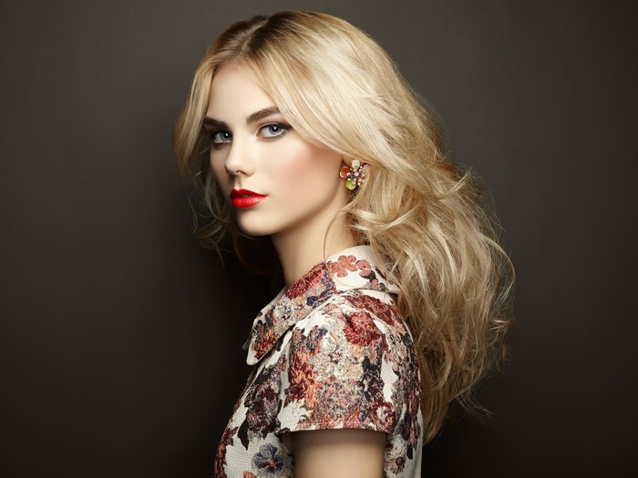 Beautiful blonde woman with red lipstick and floral dress