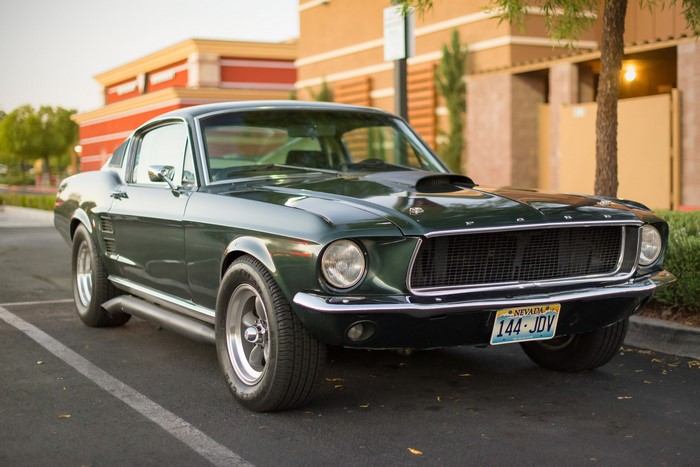 Green Ford Mustang parked on asphalt