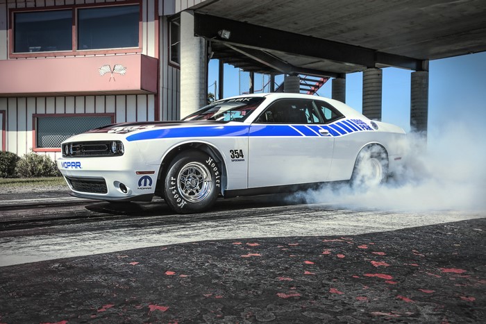 White Mopar Dodge Challenger Drag Pak car doing a burnout