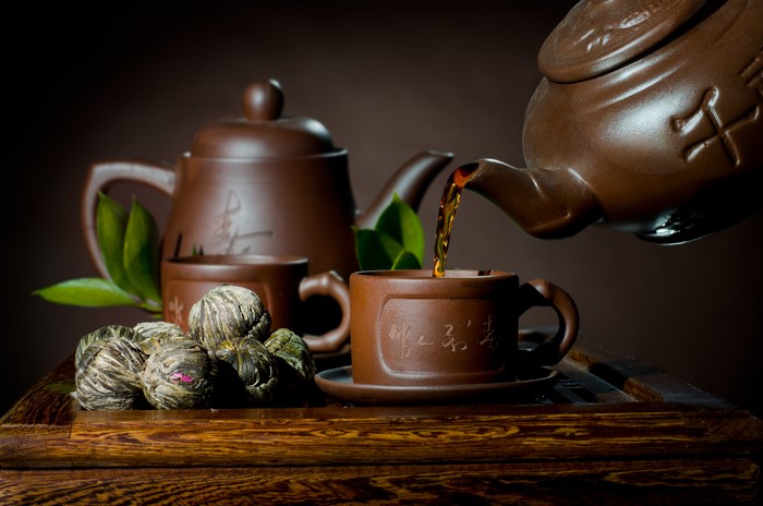 Tea pouring into a cup from a teapot