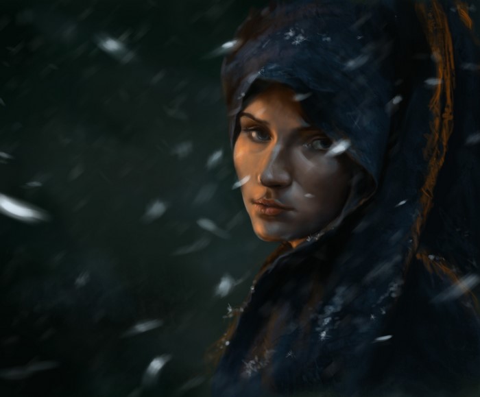 Woman in a dark hood in the snow