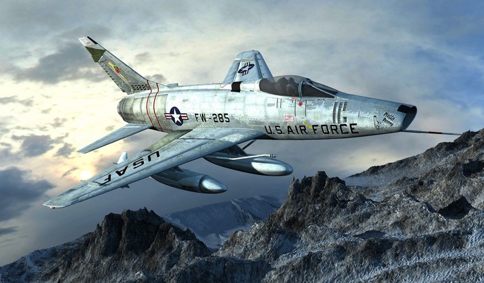 F-100 Super Sabre fighter jet flying over mountains