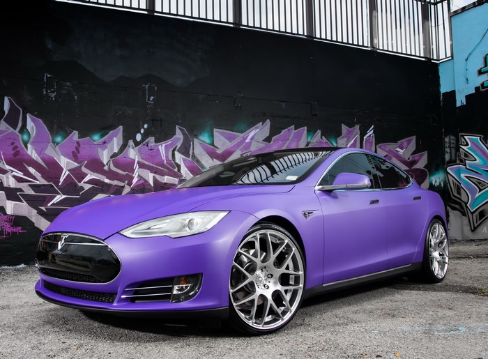 Violet Tesla Model S P85 in front of graffiti