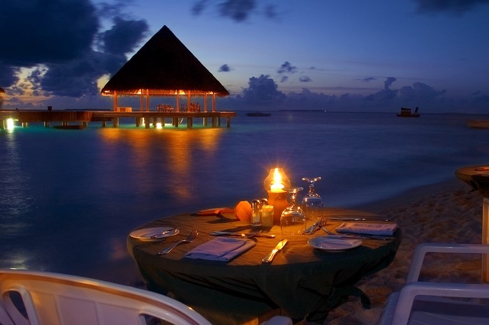 Romantic beach dinner at night with ocean view