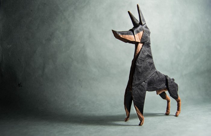 Origami Doberman Pinscher on a textured background
