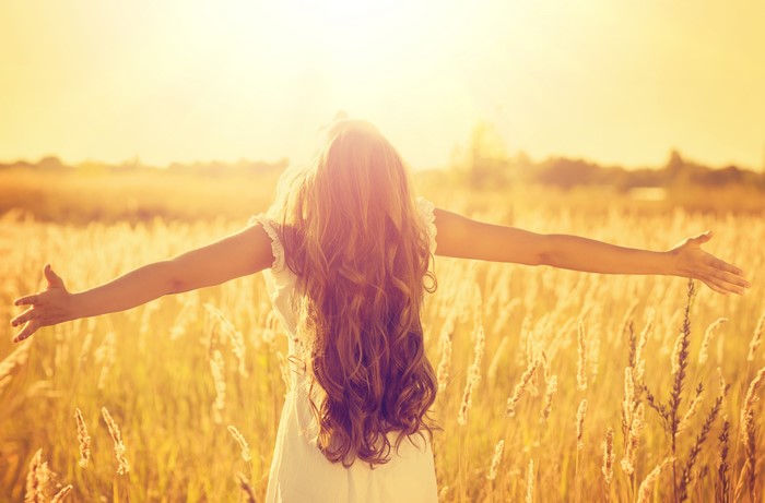 Woman with long brown hair in a field