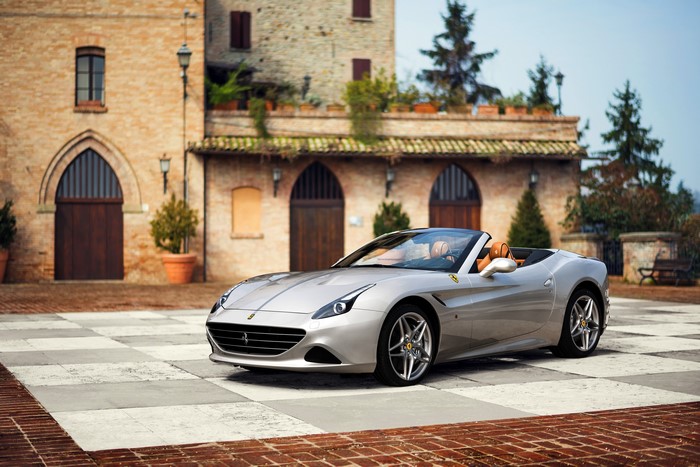 Silver Ferrari California T Convertible in front of a brick building