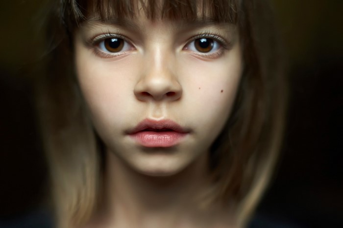 Close-Up Portrait of a Young Girl with Brown Eyes