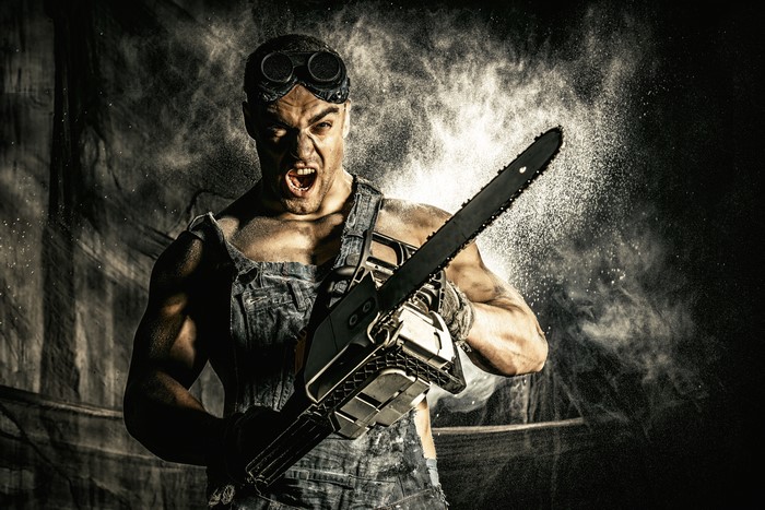 Man with chainsaw and goggles