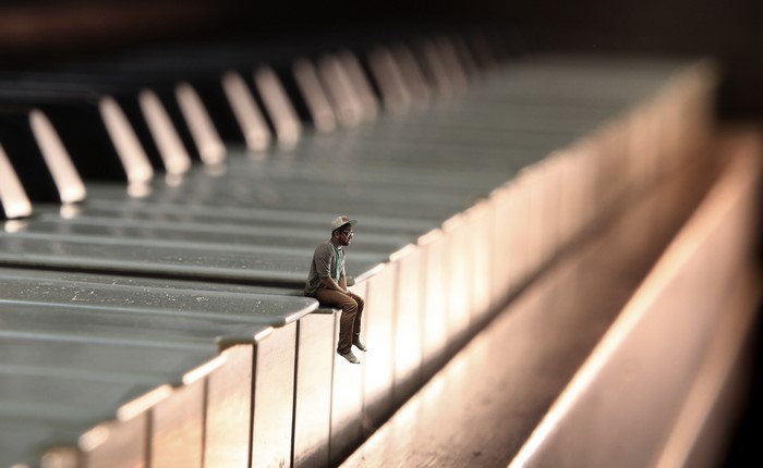 Man sitting on piano keys