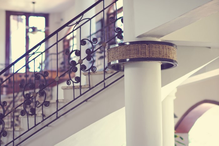 Stairs with ornate railing and pillar